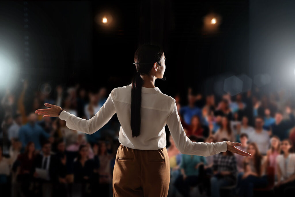 woman leader speaking in front of audience